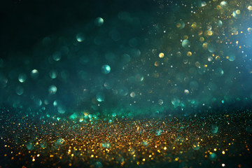 abstract glitter lights background. black, blue, gold and green. de-focused