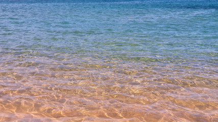 turquoise blue crystal water of a beach.
