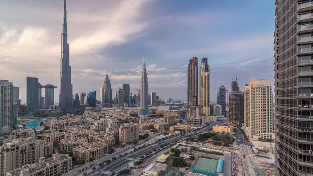 Dubai Downtown skyline day to night transition timelapse with Burj Khalifa and other skyscrapers paniramic view after sunset from the top in Dubai, United Arab Emirates. Traditional and modern