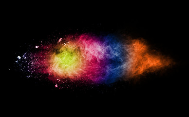 Abstract powder splatted background. Colorful powder explosion on black background. Colored cloud....