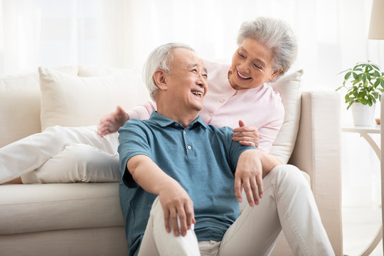 Happy senior couple talking in living room
