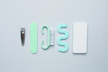 Pedicure manicure tools , nail file, pedicure scissors and separator for the fingers on blue background
