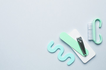 Top view of manicure and pedicure equipment on blue background with space for your text