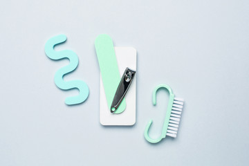 Pedicure manicure tools , nail file, pedicure scissors and separator for the fingers on blue background