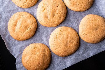 Homemade shortbread cookies on parchment paper in baking tray top view