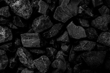 Natural fire ashes with dark grey black coals texture. It is a flammable black hard rock.  Space for text. 