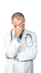 desperate doctor holds his head up with one hand. Concept of stress and failure at work.