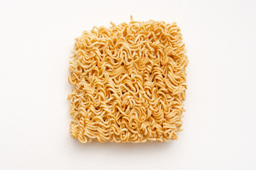 Yellow instant noodle of uncook food on white background with copyspace.  