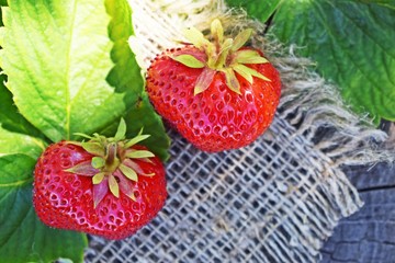 Fresh,sweet strawberries on wooden background and burlap.Healthy fruit.