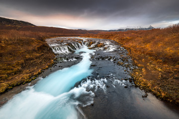 Landscape in Iceland waterfall sun mountains light golden hour road