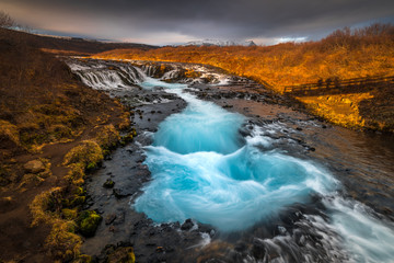 Landscape in Iceland waterfall sun mountains light golden hour road