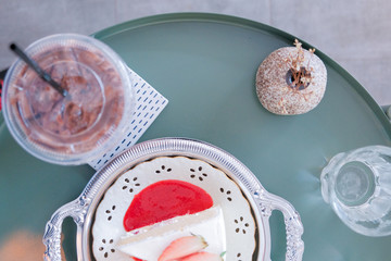 top view of Strawberry shortcake on plate with ice chocolate ,in cafe background and copy space for text