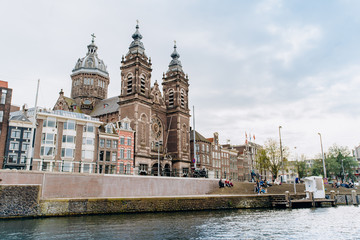 Fototapeta na wymiar Amsterdam, Netherlands September 5, 2017: Nice and huge St. Nicolas church in Amsterdam city center near the main railway station on the canal's embankment