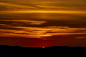 Red and orange sunset sky near Ceske Budejovice city in spring evening