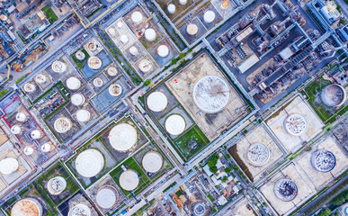 Fototapeta premium Oil storage tank with oil refinery background, Oil refinery plant at day. Aerial view from drone top view
