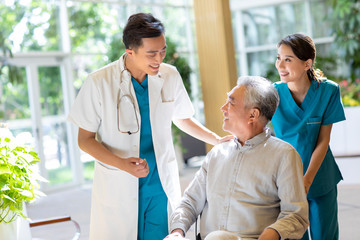 Young doctor talking with patient in nursing home