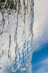 transparent falling water vertical flows, close up