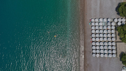 Aerial photo of tropical exotic island bay with beautiful emerald sea and deep blue cloudy sky