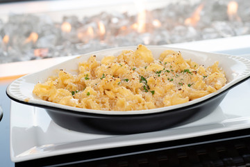 Mac and cheese served in a rarebit bowl on a white plate