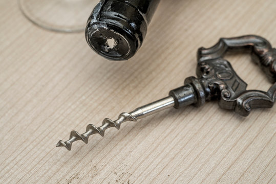 Vintage Wine Opener, Glass And Wine Bottle On A Wooden Background