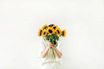 Rolgordijnen Young girl with sunflowers bouquet in hands on white background. Summer floral hero header composition. © Floral Deco