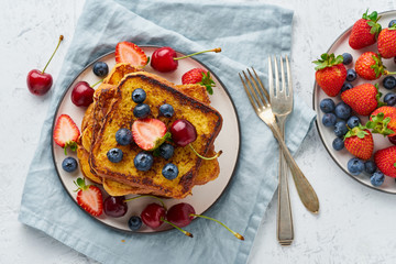 French toasts with berries, brioche breakfast, white background top view