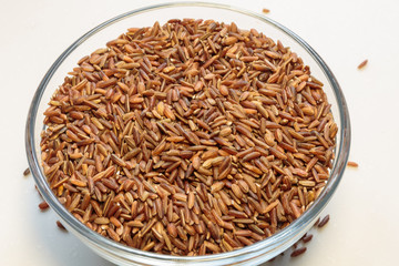 Brown rice grains isolated on white background.
