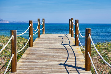 Fototapeta premium Wooden Footbridge Accessing Sa Canova Beach