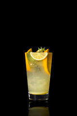 Lemonade with mint leaves,ice and a few slices of lemon on the black isolated background