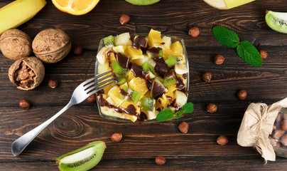 fruit salad in a plate on a wooden background