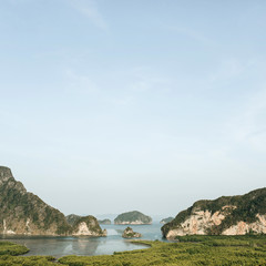 Fototapeta premium Exotic and tropical islands with rocks, blue sea and clear sky at Ao Phang-nga National Park, Thailand.