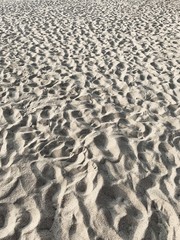 Tropical beautiful beach with white sand and many foot steps. Summer travel or vacation concept. Neutral background.