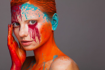 Portrait of a model in an expressive creative style using an unusual make-up