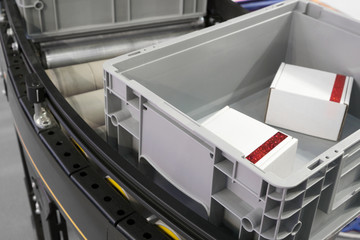 Plastic Crates at Conveyor Rollers in Factory Production or warehouse storage and sorting