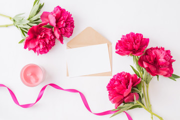 Mockup white greeting card and envelope with red peonies on a white background