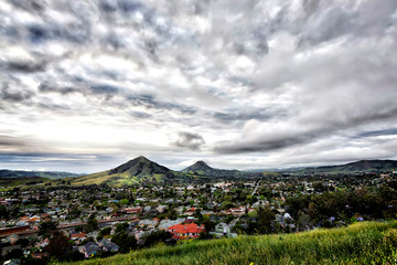 Fototapeta premium Overcast day over Mountains and valley, City