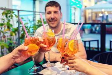 Friends toasting with cocktails at restaurant