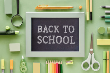  Stationary items on green paper background, text 