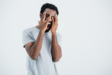 african american man in grey t-shirt screaming and crying isolated on grey