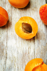 apricots with slices on a wooden background