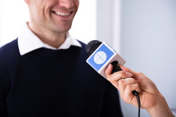 News Reporter Asking Question To Businessman