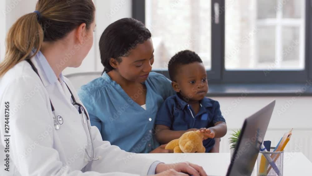 Sticker medicine, healthcare and pediatry concept - african american mother with baby son and caucasian doctor with laptop computer at clinic