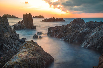 sunset on coast of sea