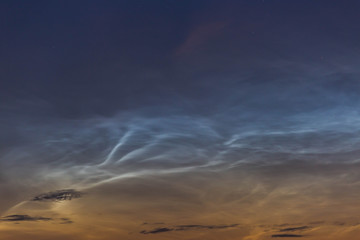 noctilucent clouds at midnight in the sky