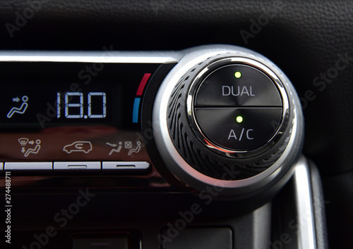 button for activating the air conditioners on the dashboard passenger car