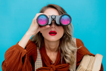 Young teacher with books and binocular