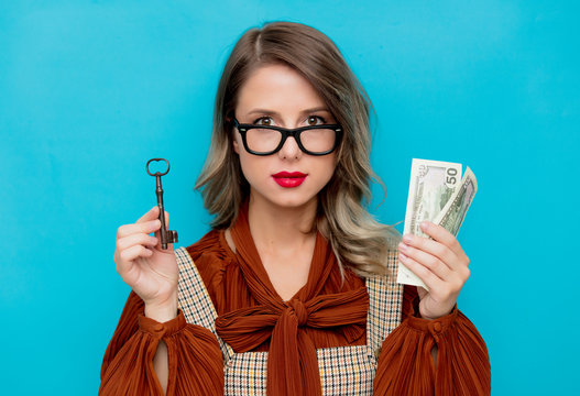 Young Woman With Key And Money