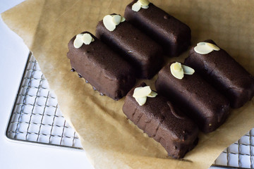 Raw vegan chocolate bars. Healthy desserts, close up