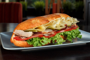 delicious sandwich with meat, cheese and vegetables