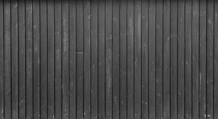 High resolution full frame background of a weathered wood board wall or paneling in black and...